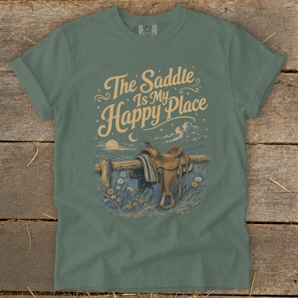 Green t-shirt with "The Saddle Is My Happy Place" text and saddle on a fence.