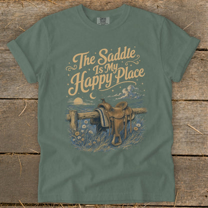 Green t-shirt with "The Saddle Is My Happy Place" text and saddle on a fence.
