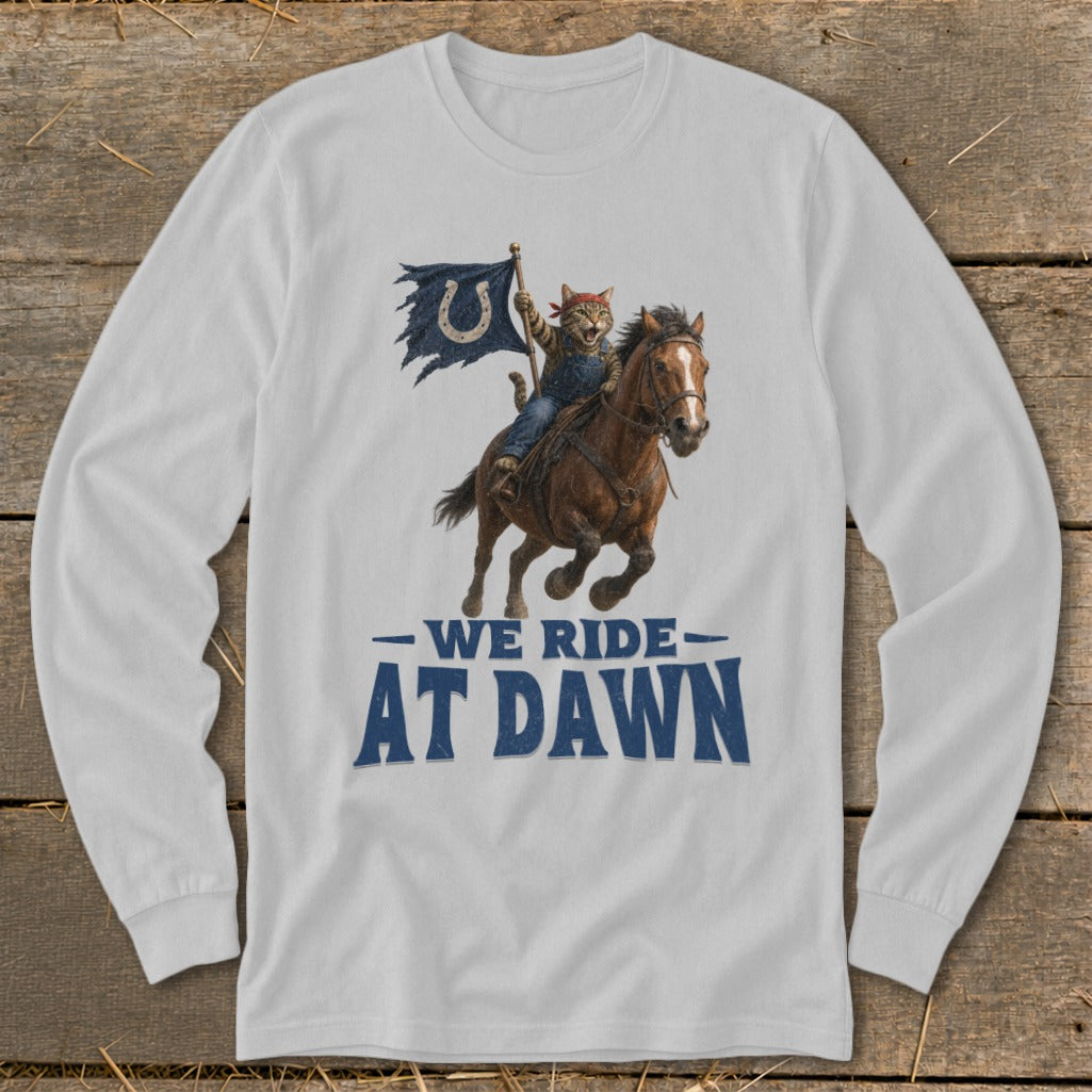 Cat on horseback holding a tattered flag with a horseshoe, text reads "WE RIDE AT DAWN".