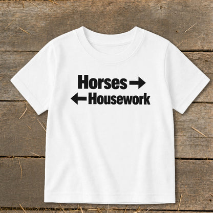 White short-sleeved t-shirt with black text that reads "Horses" with a right arrow and "Housework" with a left arrow.
