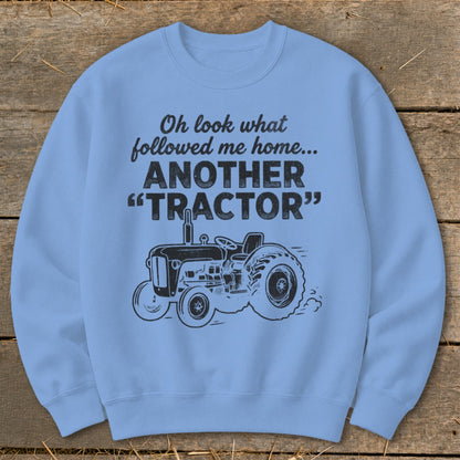 Light blue sweatshirt with black text and tractor graphic.