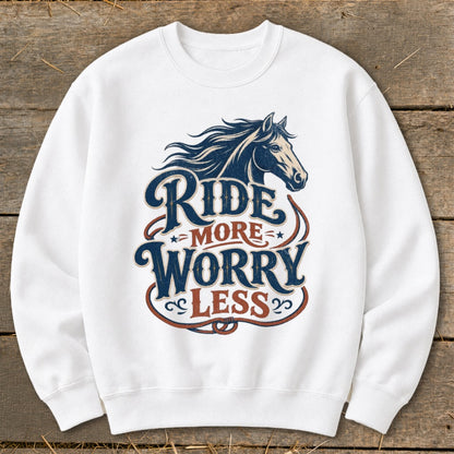 White sweatshirt with "Ride More Worry Less" text and horse graphic.