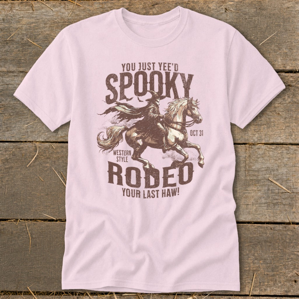 Pink t-shirt with "You Just Yee'd Spooky Western Style Rodeo" Halloween graphic.