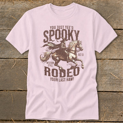 Pink t-shirt with "You Just Yee'd Spooky Western Style Rodeo" Halloween graphic.