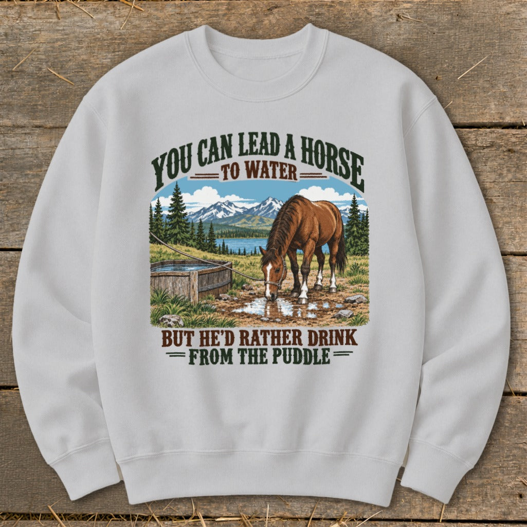 A light grey crewneck sweatshirt featuring a graphic of a horse drinking from a puddle with text above and below.