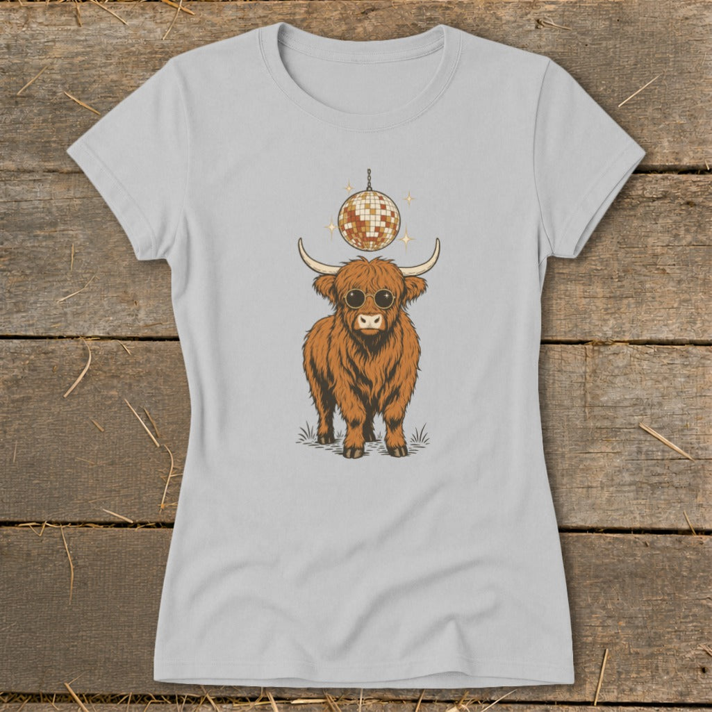 Highland cow wearing sunglasses under a disco ball graphic on a light gray t-shirt.