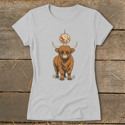 Highland cow wearing sunglasses under a disco ball graphic on a light gray t-shirt.