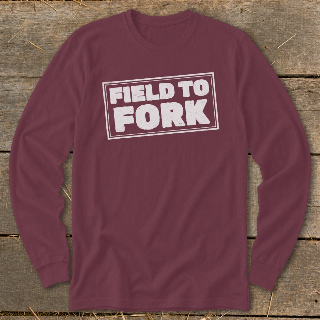 Maroon long-sleeve t-shirt with a white rectangular border enclosing the distressed text "FIELD TO FORK".