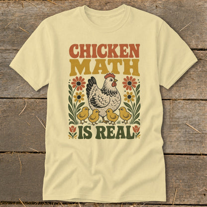 Cream t-shirt with "Chicken Math Is Real" graphic and illustrated chickens and flowers.