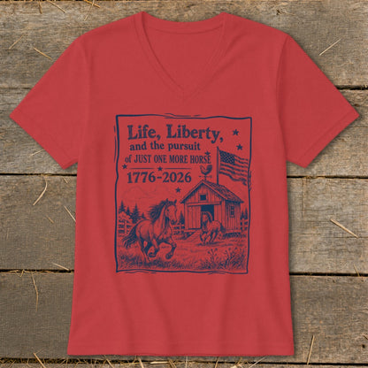 Red v-neck t-shirt with navy graphic: "Life, Liberty, and the pursuit of JUST ONE MORE HORSE 1776-2026"