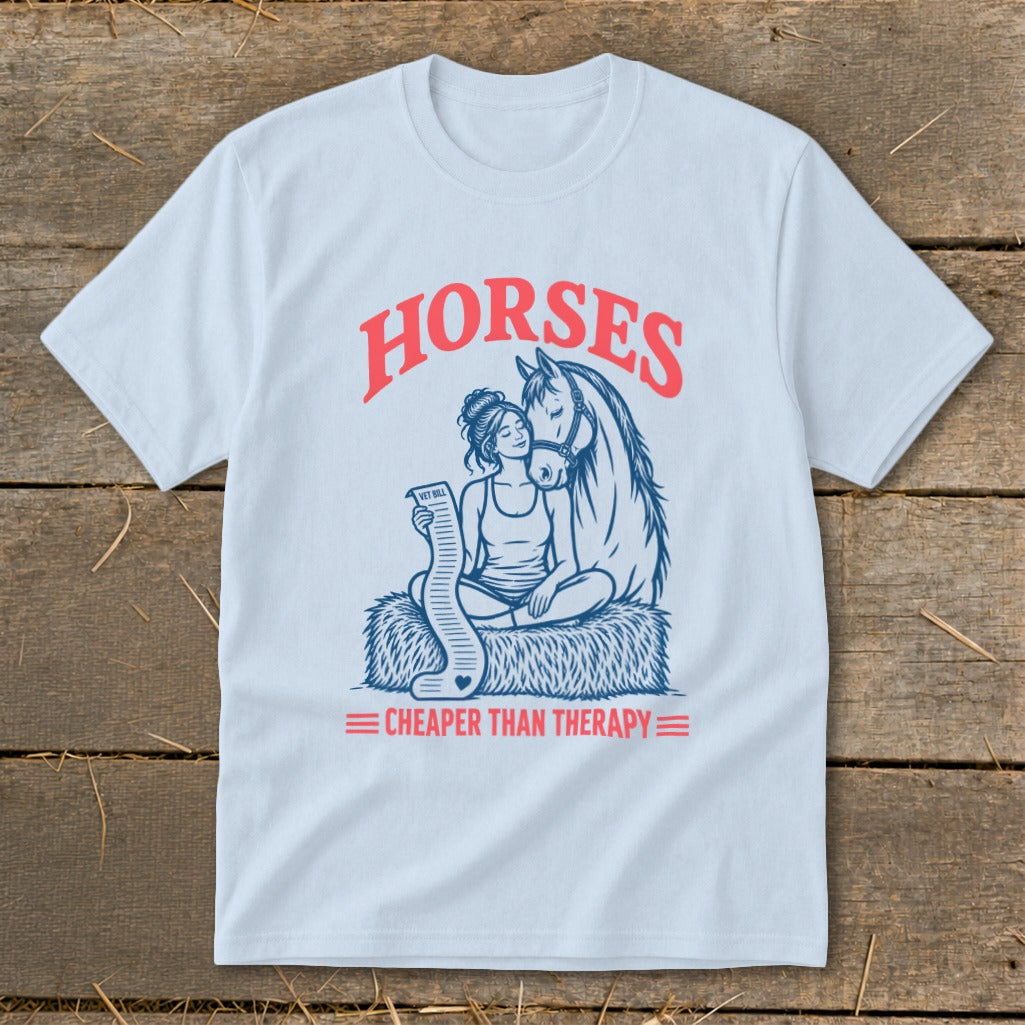 Light blue t-shirt with "HORSES CHEAPER THAN THERAPY" and graphic of woman with horse.