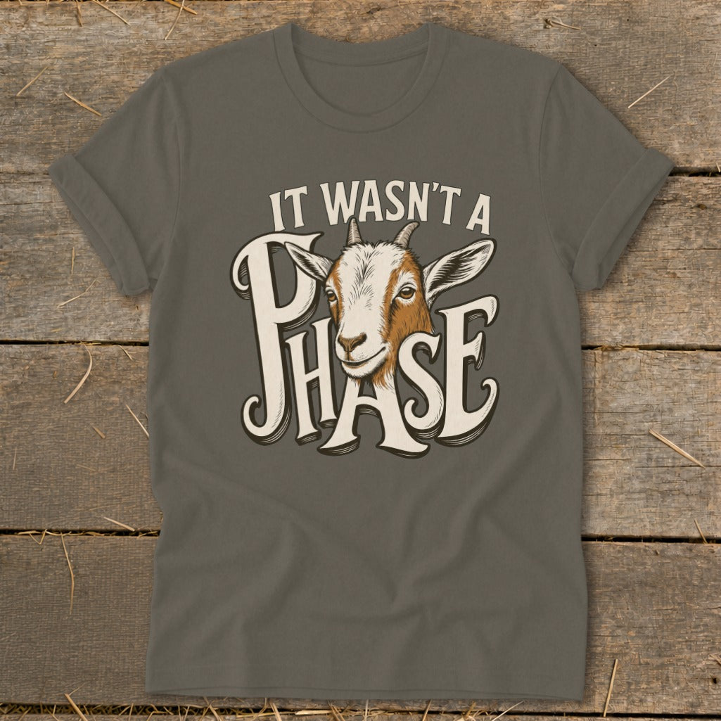 Goat illustration with text "It Wasn't A Phase" on a gray t-shirt.