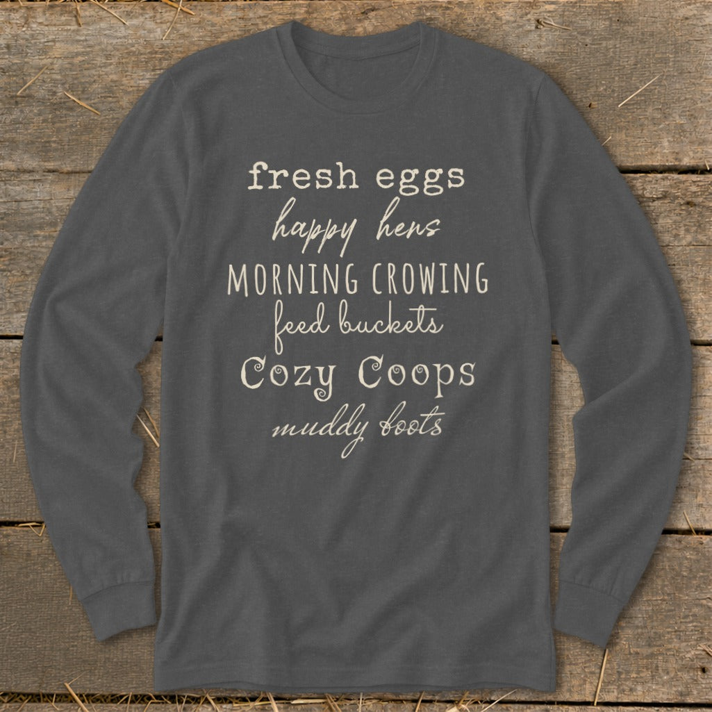 Gray long-sleeve shirt with text: "fresh eggs happy hens MORNING CROWING feed buckets Cozy Coops muddy boots".
