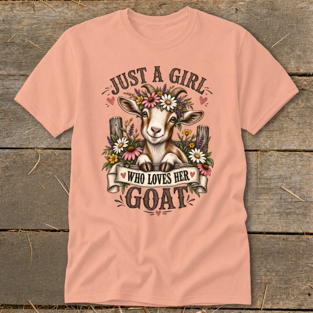 Peach t-shirt with a goat wearing flowers, text reads "Just a girl who loves her goat."