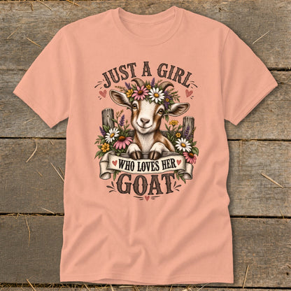 Peach t-shirt with a goat wearing flowers, text reads "Just a girl who loves her goat."