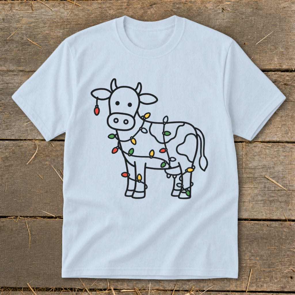 Light blue t-shirt with black line drawing of a cow covered in colorful Christmas lights.