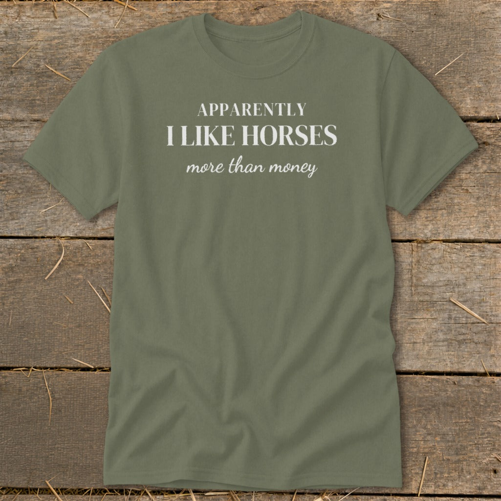 Olive green t-shirt with white text: "APPARENTLY I LIKE HORSES more than money".