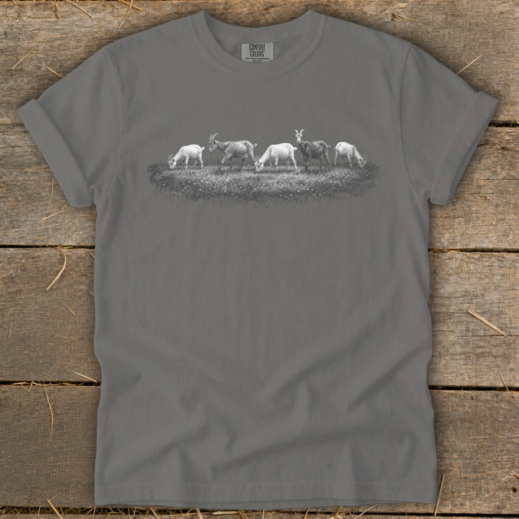 Charcoal grey t-shirt with a sketch of five goats grazing in a field.