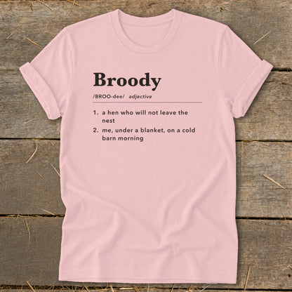 Pink t-shirt with "Broody" definition: hen not leaving nest and you under blanket.