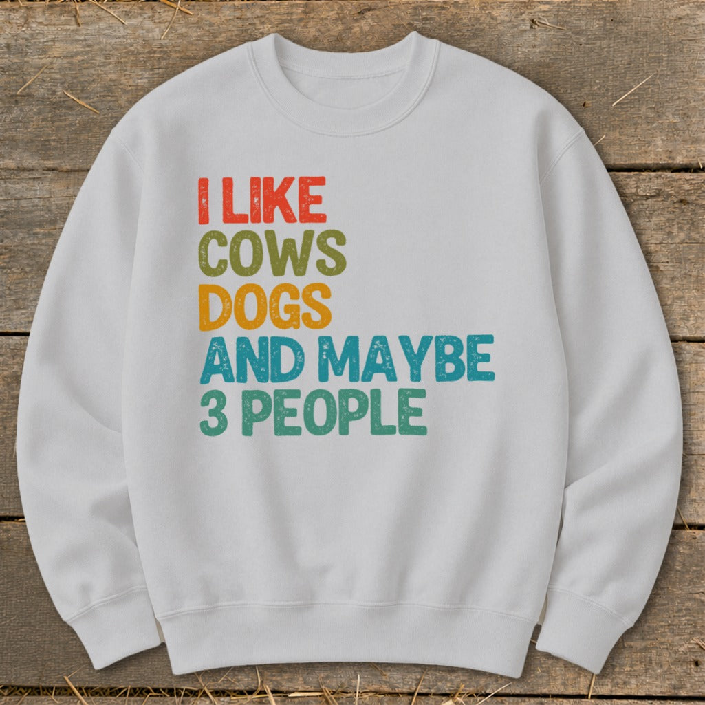 White sweatshirt with "I like cows dogs and maybe 3 people" text.