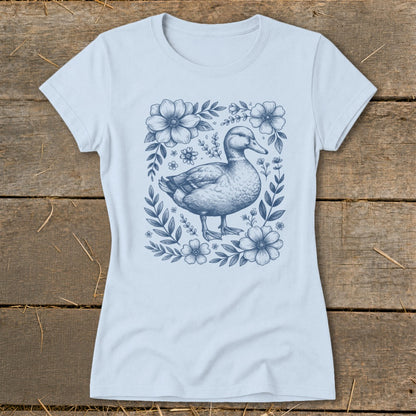 Light blue t-shirt with a blue line drawing of a mallard duck surrounded by flowers.