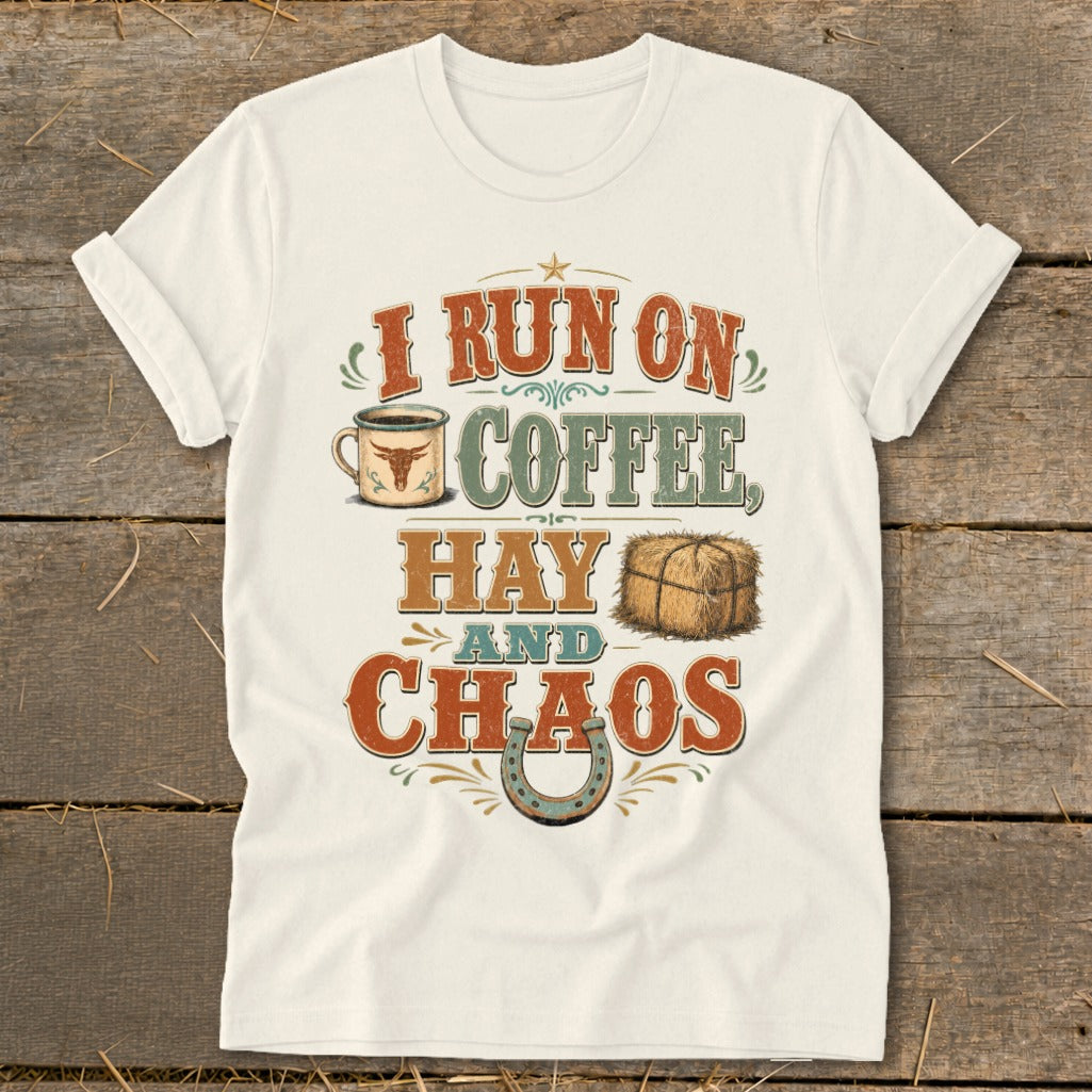 White t-shirt with distressed text "I run on coffee, hay and chaos" and graphics.