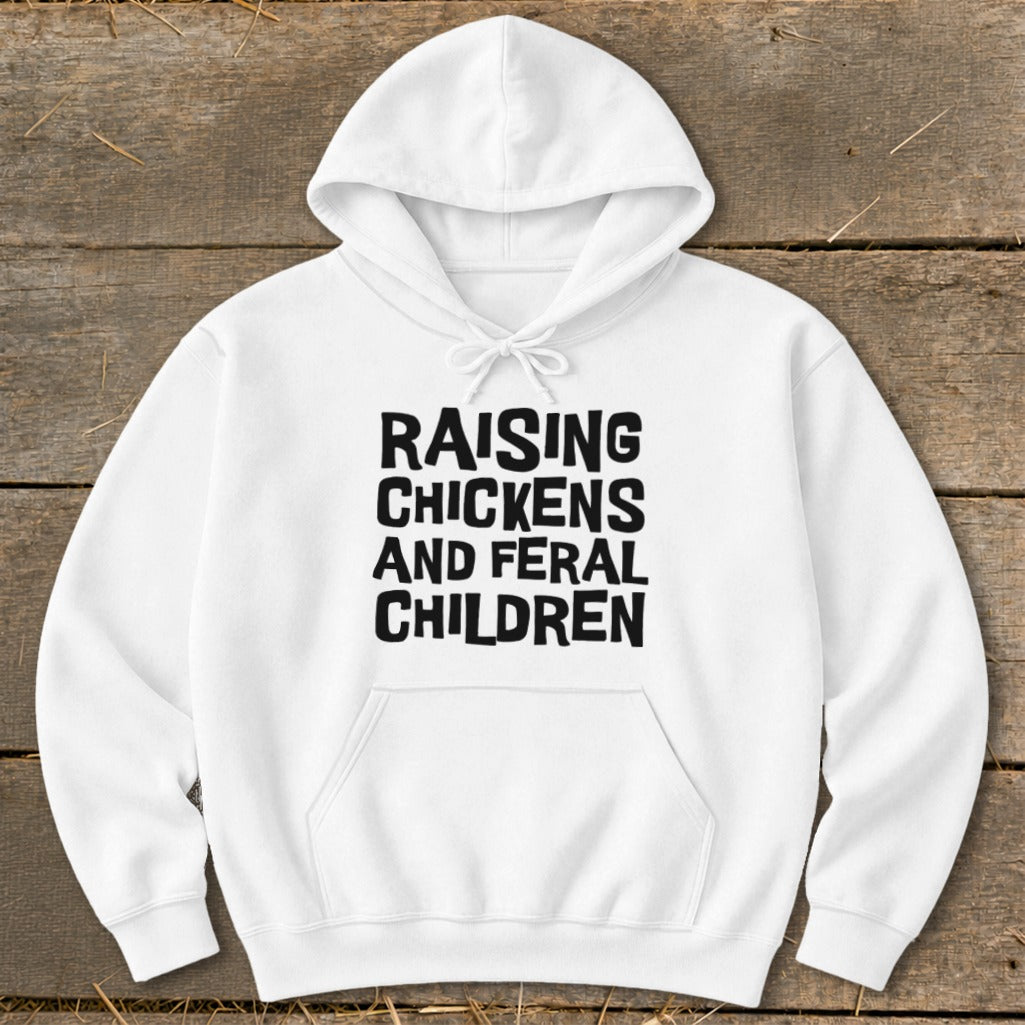 White hoodie with black text reading "RAISING CHICKENS AND FERAL CHILDREN".