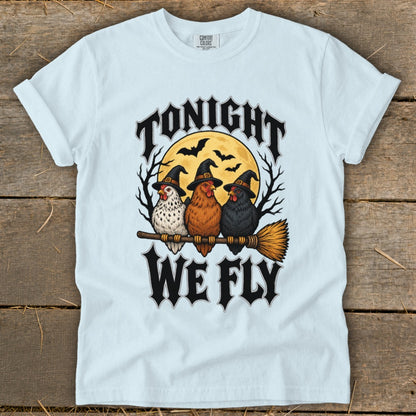 Three chickens wearing witch hats sit on a broomstick with "TONIGHT WE FLY" text.