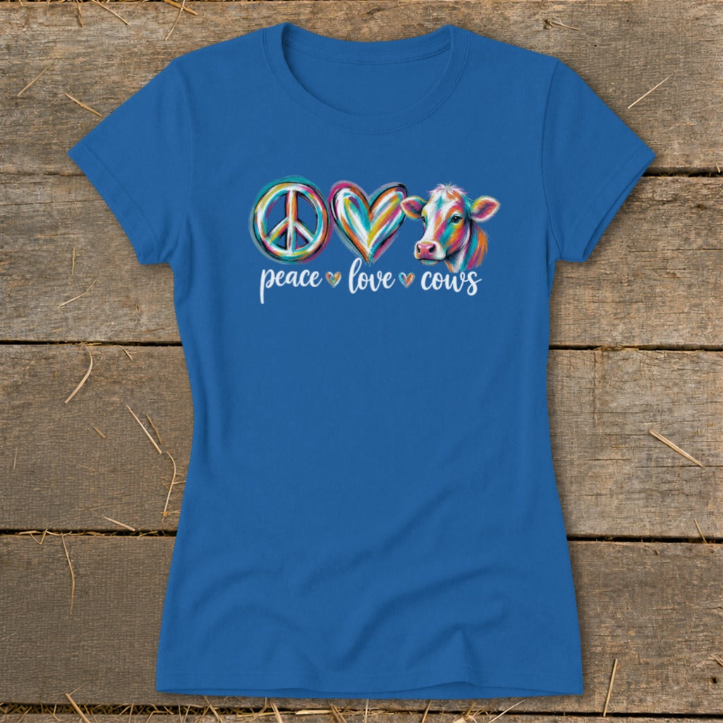 Blue t-shirt with a colorful peace sign, heart, and cow illustration above the words "peace love cows".