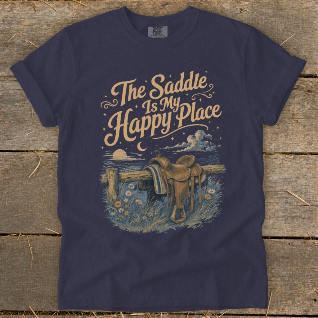 T-shirt graphic: "The Saddle Is My Happy Place" with a saddle on a fence at night.