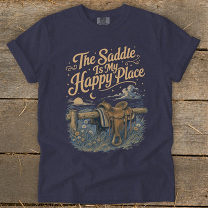 T-shirt graphic: "The Saddle Is My Happy Place" with a saddle on a fence at night.