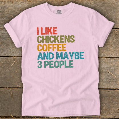 Pink t-shirt with text "I like chickens, coffee and maybe 3 people".