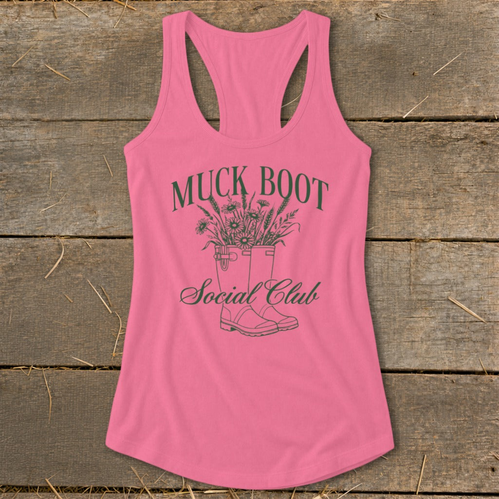 Pink tank top with "Muck Boot Social Club" text and illustration of boots with flowers.