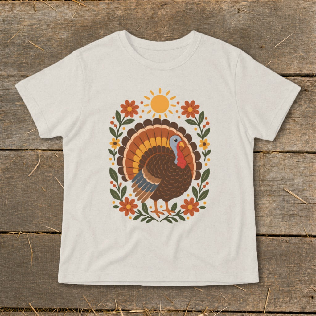Thanksgiving turkey design with flowers and sun on a light t-shirt.