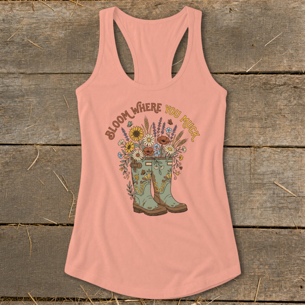 Peach tank top with boots and flowers graphic reading "Bloom Where You Muck".