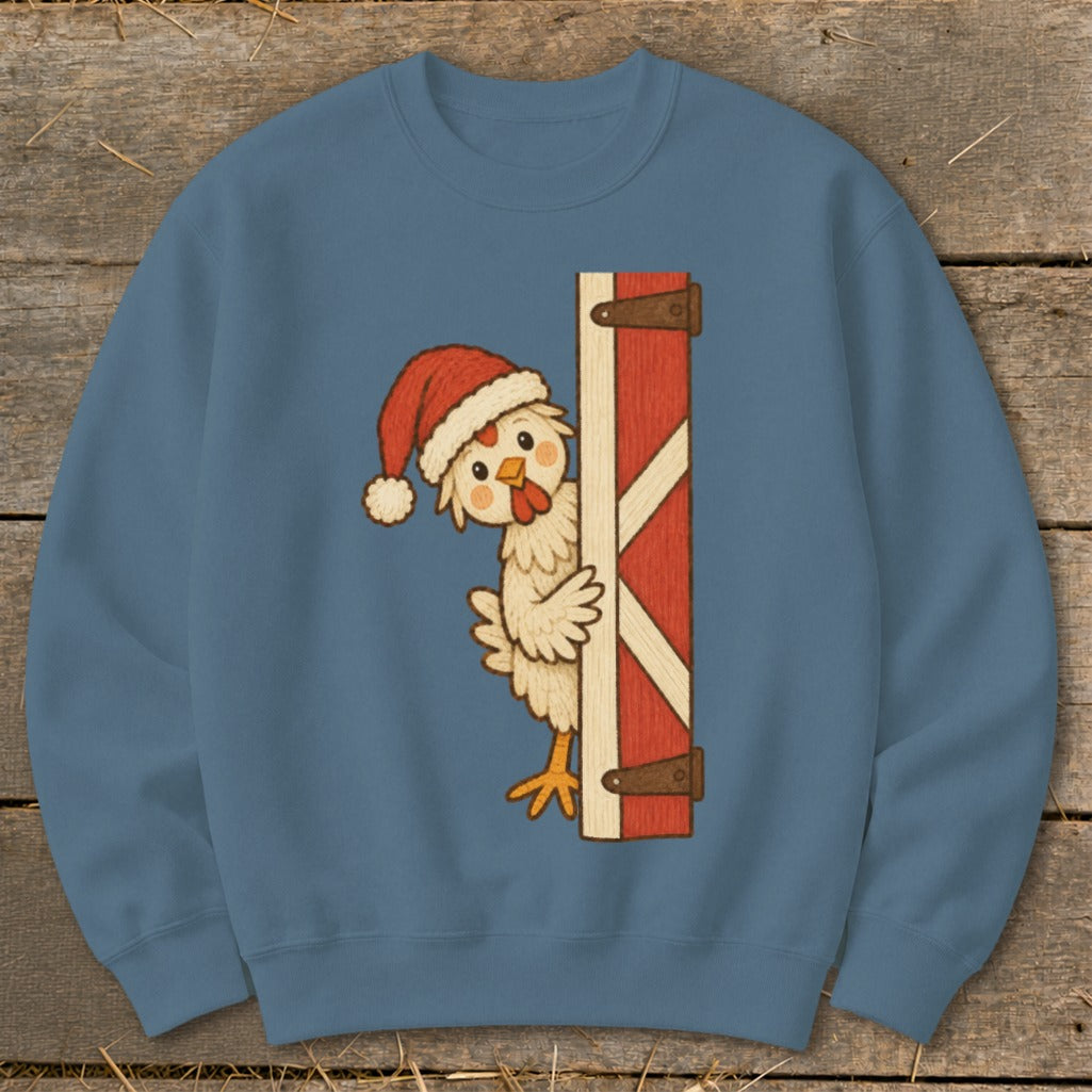 Chicken wearing Santa hat peeks from behind a red barn door.