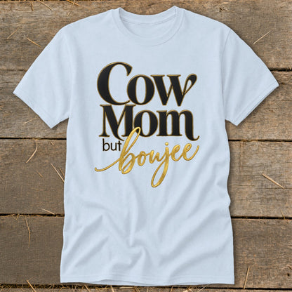 White t-shirt with "Cow Mom but boujee" text in gold and black.