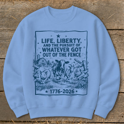 Light blue sweatshirt with graphic of farm animals and text "Life, Liberty, and the Pursuit of Whatever Got Out of the Fence 1776-2026".