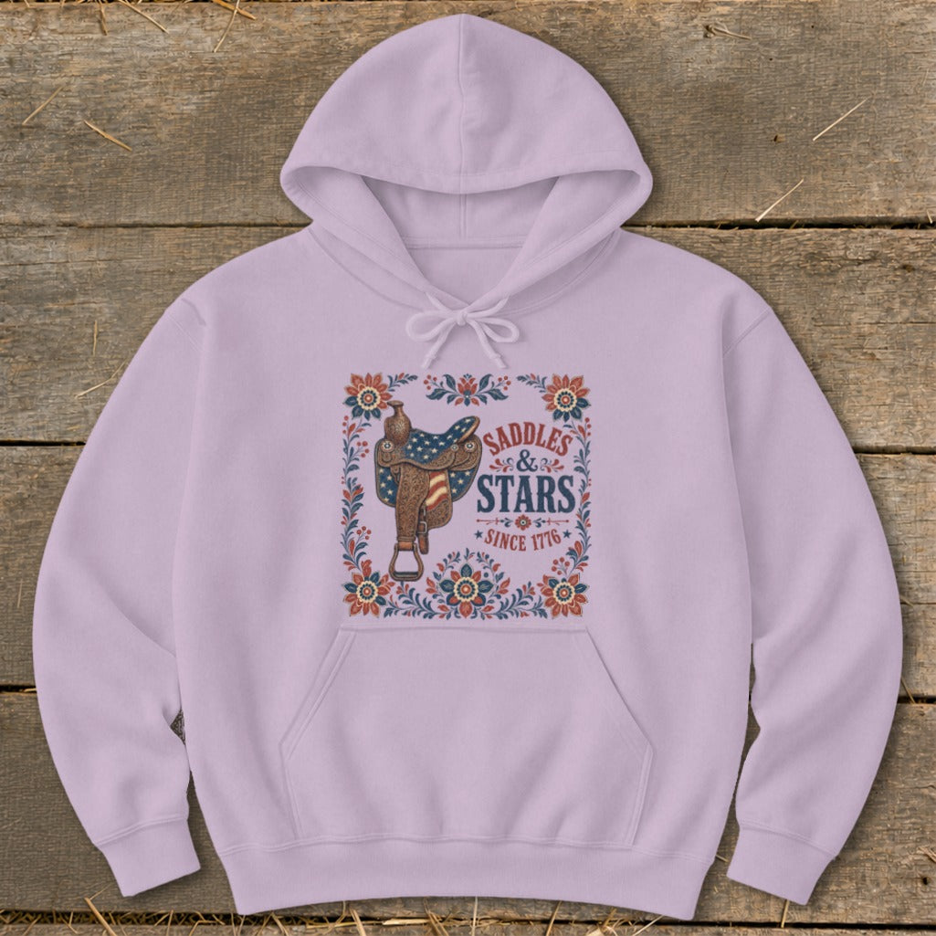 Lavender hoodie with a saddle graphic featuring the US flag and text "Saddles & Stars Since 1776".