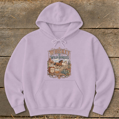 Light purple hoodie with "Whiskey Wild Horses" graphic featuring running horses, cacti, and a whiskey bottle.