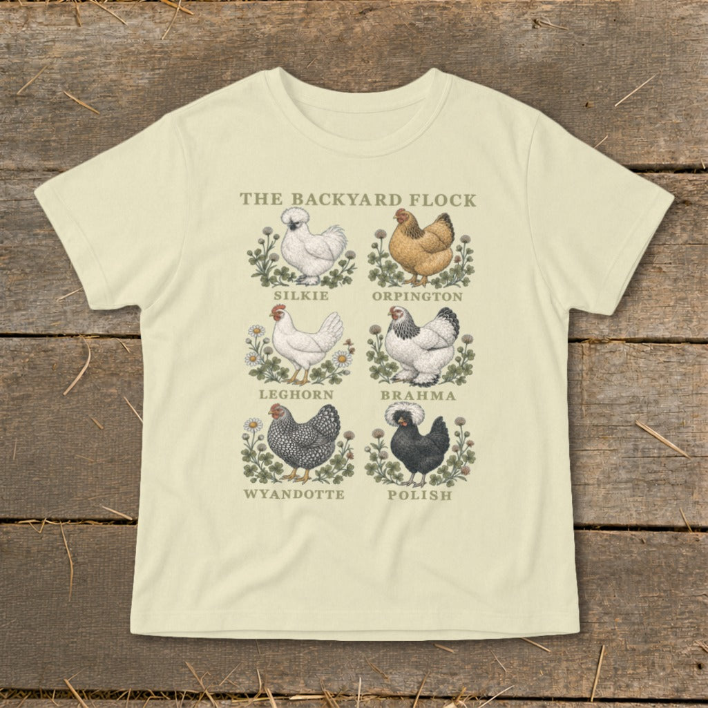 Cream t-shirt with "The Backyard Flock" and illustrations of Silkie, Orpington, Leghorn, Brahma, Wyandotte, and Polish chickens.