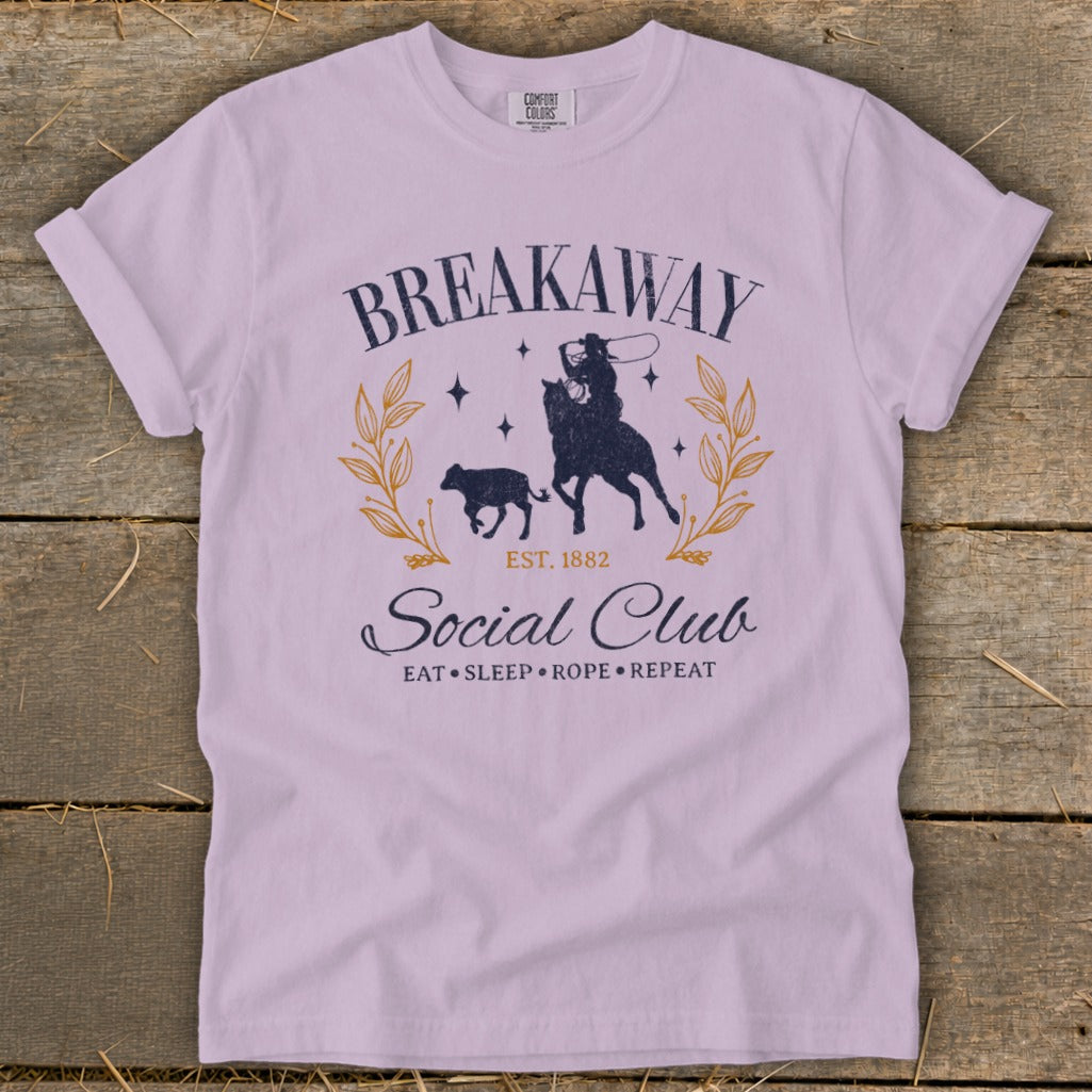 Light purple t-shirt with "Breakaway Social Club Est. 1882" and cowboy roping a calf.
