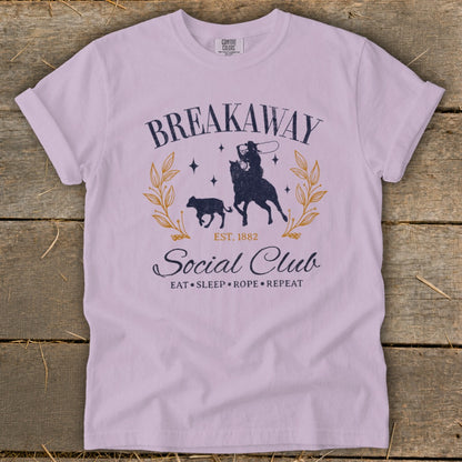 Light purple t-shirt with "Breakaway Social Club Est. 1882" and cowboy roping a calf.
