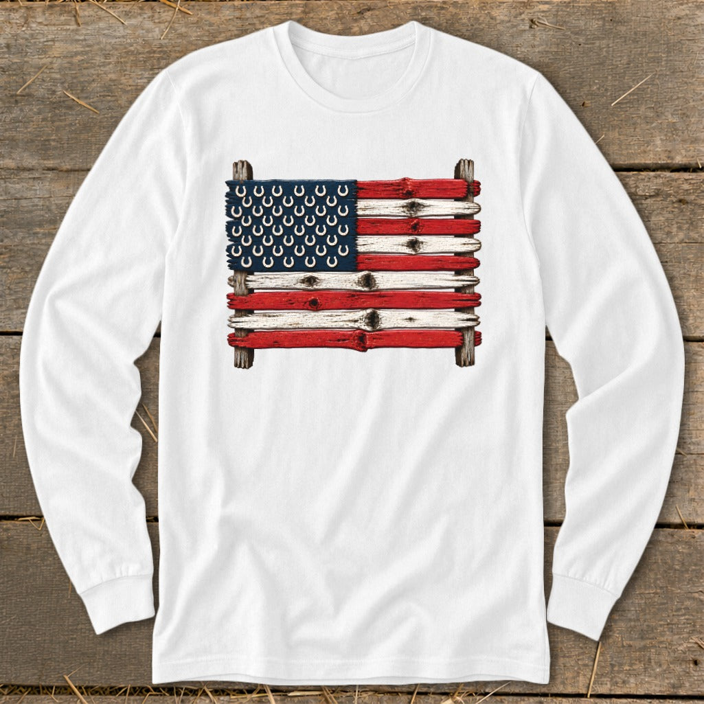 White long-sleeve shirt printed with an American flag graphic made of weathered wood planks and horseshoes.