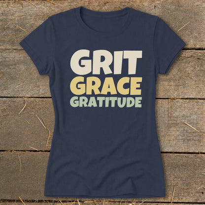Dark blue women's t-shirt printed with the words Grit, Grace, and Gratitude in stacked, blocky lettering.