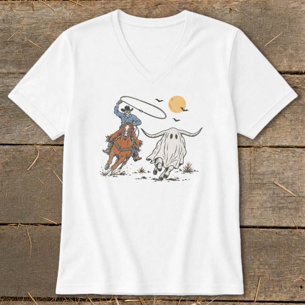 Skeleton cowboy on horseback lassoing a longhorn ghost under a yellow moon.