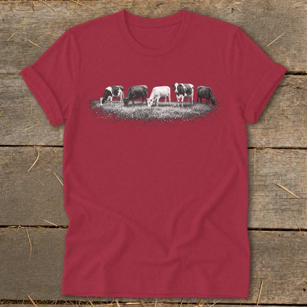 Red t-shirt with a graphic of five cows grazing in a field.