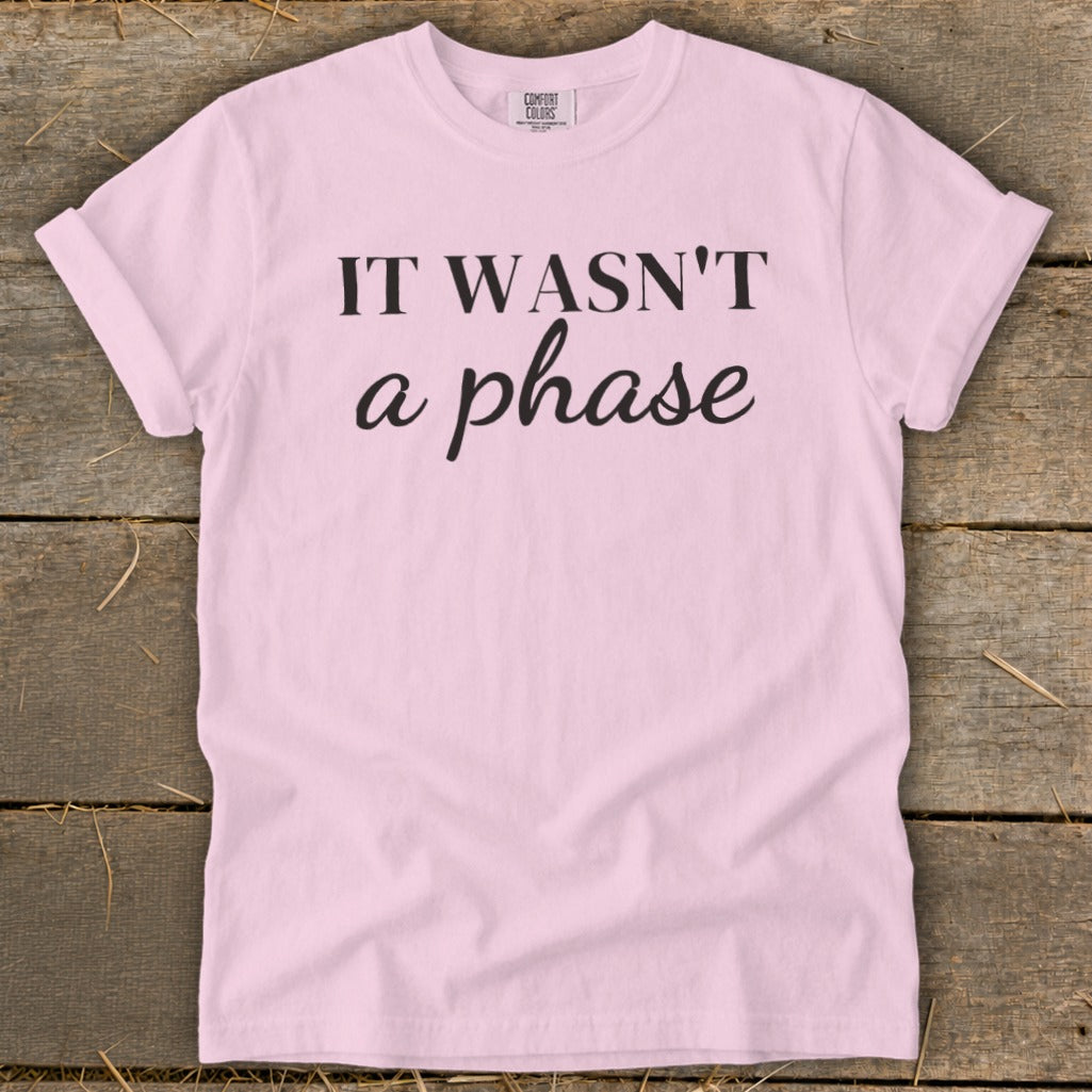 Light pink t-shirt with black text reading "IT WASN'T a phase".