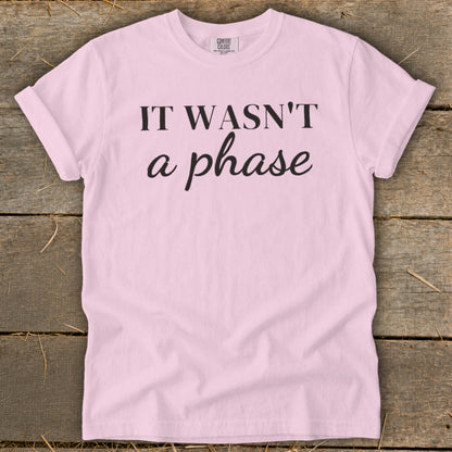 Light pink t-shirt with black text reading "IT WASN'T a phase".