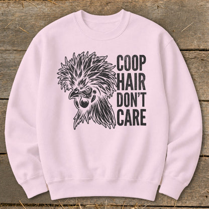 Pink crewneck sweatshirt with a black graphic of a stylized chicken and the text "COOP HAIR DON'T CARE".